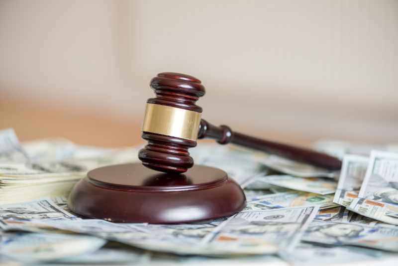 Wood gavel and cash
